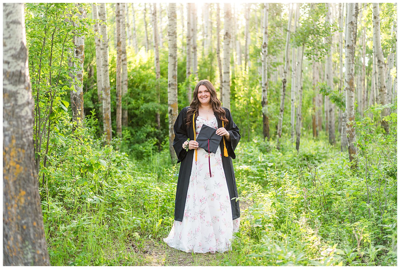 Sylvan lake grad session surrounded by trees at golden hour Cap and gown